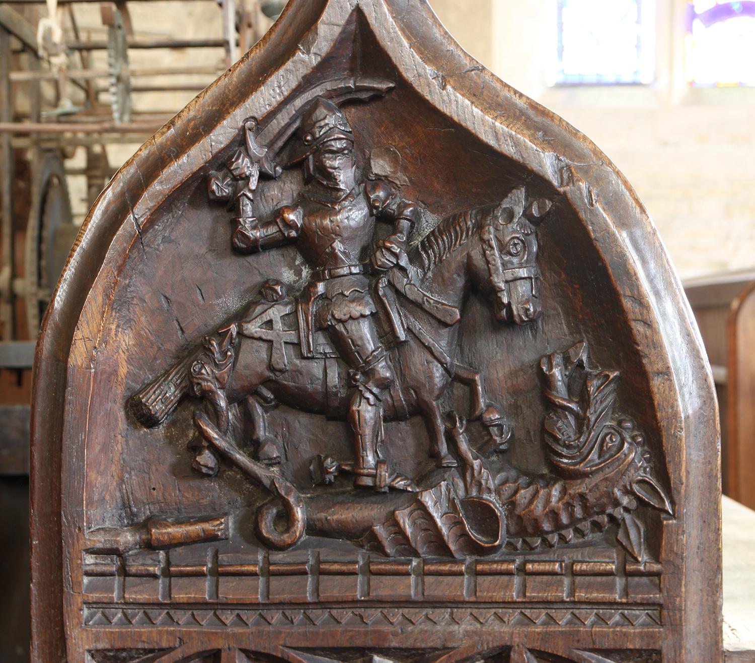 A medieval carved bench end showing a mounted figure