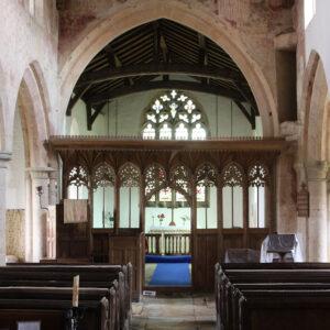 A medieval rood screen and wall paintings inside a Lincolnshire church