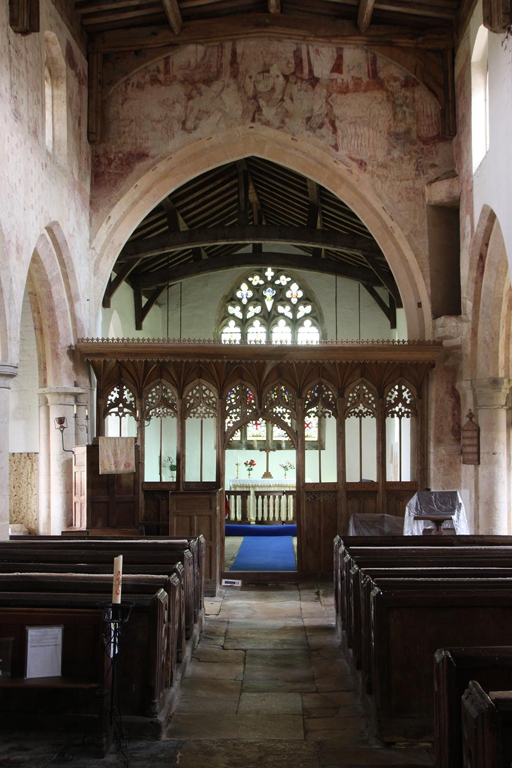 A medieval rood screen and wall paintings inside a Lincolnshire church