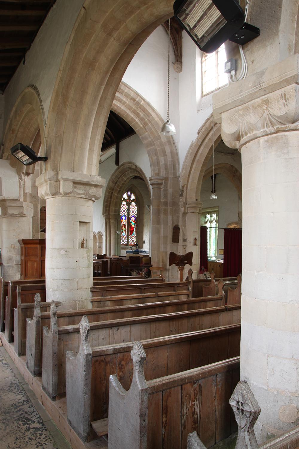 Stone arches and wooden pews inside a Lincolnshire church