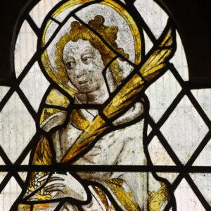 A medieval figure depicted in stained glass
