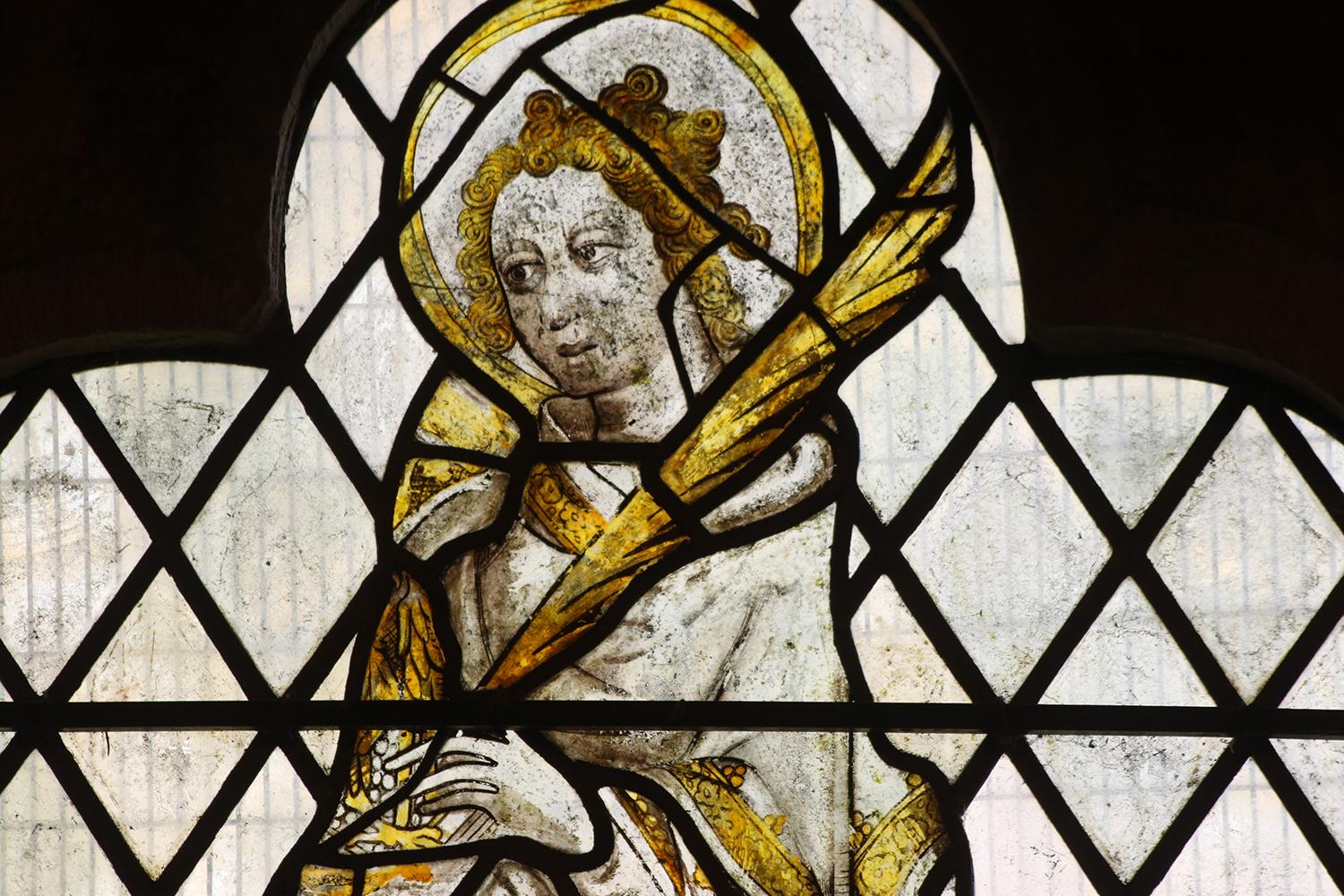 A medieval figure depicted in stained glass